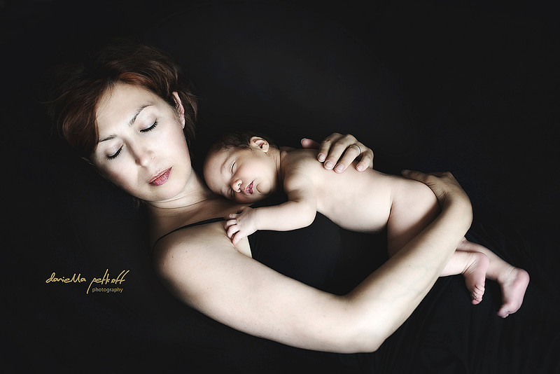 Mother with baby sleeping on her chest