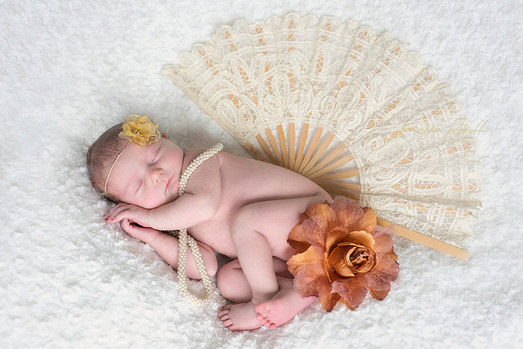 Newborn girl Gatsby style with fan, pearls and large flower