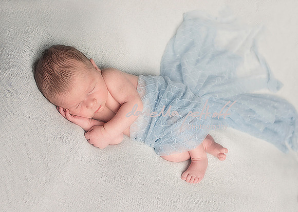 sleeping newborn baby boy cover with blue lace